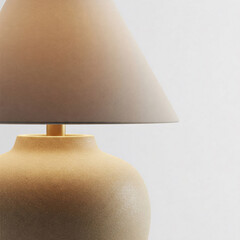 A modern table lamp with a textured brown base and a light-colored lampshade, emitting a warm, muted light