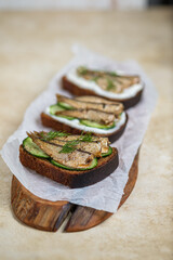 Sandwiches with sprats, mayonnaise and cucumber