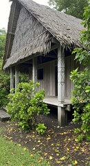 Tropical Hut with Thatched Roof, Lush Greenery, and Traditional Architecture Scenery