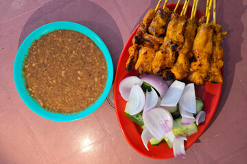 Grilled Chicken Satay Skewers with Cucumber, Onion, and Peanut Sauce
