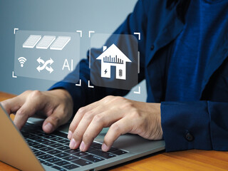 A smart home energy management concept with person typing on laptop keyboard and digital icons of solar panel and house with battery and electricity symbols, showing technology and innovation