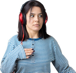A young girl in a striped vest is listening to music in red headphones in a studio and dancing.