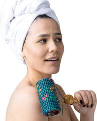 Brunette with a towel on her head using roller for face massage isolated on grey background
