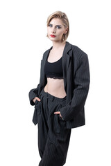 Portrait of a seductive, stylish business lady in the studio. Blonde girl in a suit and top.