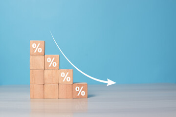 Wooden blocks with percentage sign and down arrow, financial recession crisis, interest rate fall,...