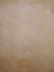 texture, pattern, rough and uneven yellow wall background, creating a lively and abstract background.