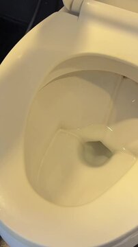 Half flush with half flow in a dual-flush toilet for economical consumption of fresh water. Eco-friendly use of plumbing, plumbing and sewerage in the bathroom. High quality 4k footage