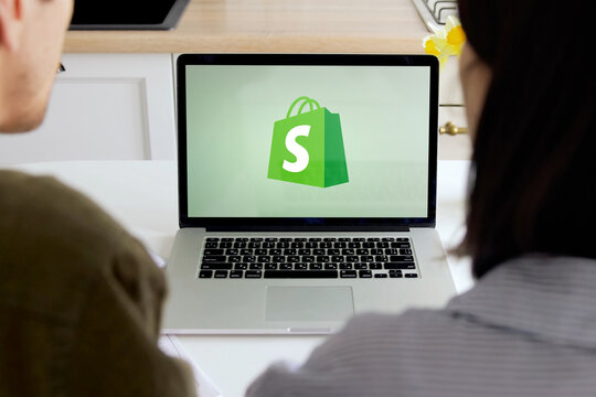 Business people working with shopify on a laptop