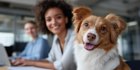 Happy dog in office with smiling female colleague in background