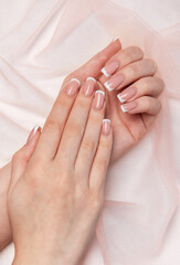 Woman showing french manicure on pink background