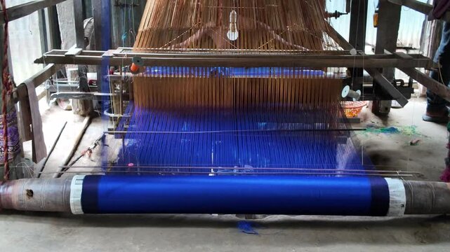 Bangladeshi man weaving in a sari factory, Dhaka Division, Delduar, Bangladesh