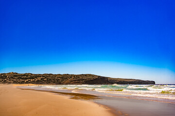 Empty Bordeira beach in Portugal. Beautiful Algarve coastline. View at sandy beach and cliffs