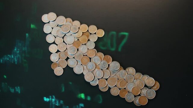 Coins Forming an Upward Arrow on a Matte Black Surface Representing Financial Growth