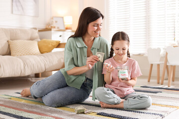 Mother giving pocket money to her daughter at home