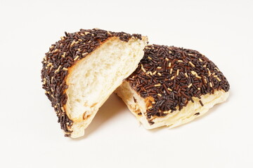 Milk bread with a soft white interior, topped generously with chocolate sprinkles and a touch of white topping. Photographed against a clean white background.