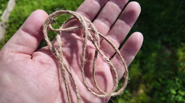 scourge. Texture of Natural Jute Twine. High-resolution texture of natural jute twine, showing its rough fibers and organic weave. scourge in hand. Jute burlap rustic twine string rope cord.