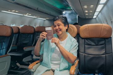 Passenger Asian Mature Woman show passport Smiling On Plane