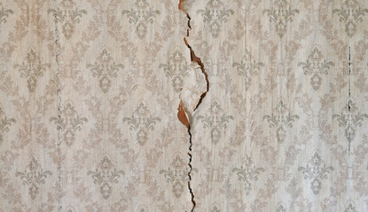 Old wallpaper on the wall. Old wallpaper for texture or background.