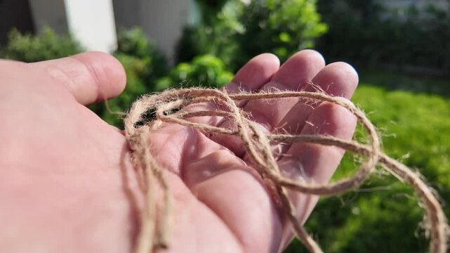 scourge. Texture of Natural Jute Twine. High-resolution texture of natural jute twine, showing its rough fibers and organic weave. scourge in hand. Jute burlap rustic twine string rope cord.