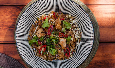 Vietnamese chicken noodles with soy sprouts, chili, fresh herbs, and leafy greens. Flat lay shots of the dish with colorful toppings