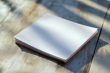 Creative blank flyer resting on polished wood surface in soft light