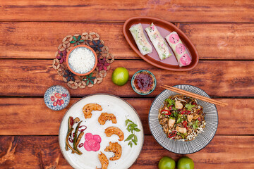 Authentic Vietnamese cuisine including pho bo, spring rolls with shrimp and noodles, fried shrimp, chicken noodles, rice, and pickled vegetables. Flat lays and styled food shots