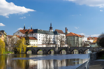 Fototapeta premium Stone Bridge Crossing Otava River in Pisek, Czechia, on Sunny Spring Day