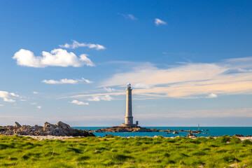Phare de la Hague lighthouse standing on rocky islet in Normandy, France