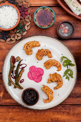 Crispy fried shrimp served with smashed cucumber salad and marinated daikon. Bright and flavorful Vietnamese dish captured in flat lay style