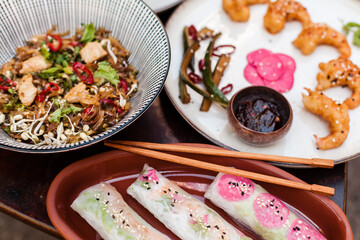 Authentic Vietnamese cuisine including pho bo, spring rolls with shrimp and noodles, fried shrimp, chicken noodles, rice, and pickled vegetables. Flat lays and styled food shots