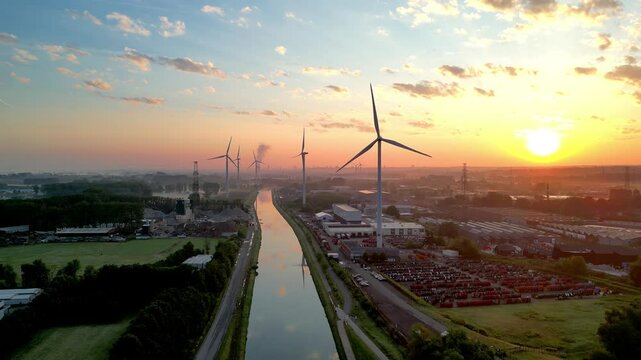 Halle, Vlaams Brabant, Belgium, 13th of May, 2025, Beautiful sunset view with wind turbines reflecting on the canal, capturing renewable energy in action. - Powered by Adobe
