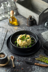 Creamy risotto with green asparagus seasoned with salt and pepper