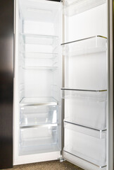 Fototapeta premium Open empty refrigerator is waiting for products