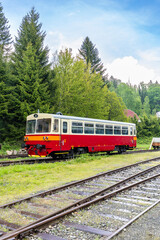 Obraz premium Red and white train waiting at Korenov station in Czechia, Liberecky kraj