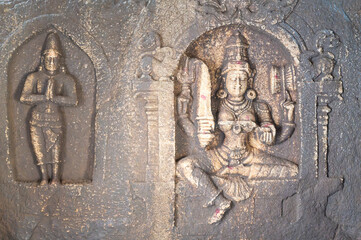 Ancient sculpture at a temple of Hampi, carved into boulder of Tungabhadra river, hindu religion, Lakshmi Narasimha shiva at ruin of Vijayanagara Empire