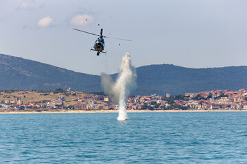 Military helicopter avoid sea mine explosion during a rescue operation. 
