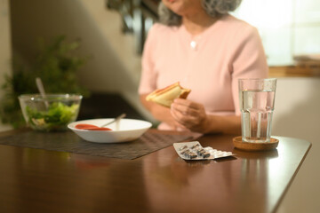 Digestive Discomfort After a Meal with Senior Woman Experiencing Bloating and Indigestion