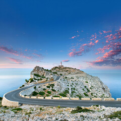 Breathtaking Sunset Over Cap Formentor Lighthouse with Winding Coastal Road and Majestic Sea Views