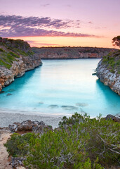 Serene Sunrise Over a Turquoise Bay Amid Cliffs on Mallorca