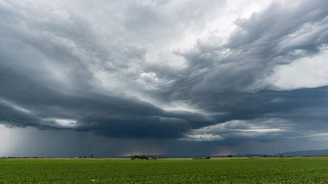 Dramatic panorama of severe storm with gathering dark clouds over Bavarian landscape Germany stormy weather approaching