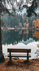 Wooden bench by a peaceful lake with a scenic view.