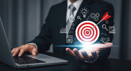 A businessman using a laptop with a target and arrow graphic hovering over his hand in a suit