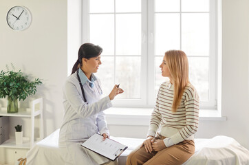 Feminist health clinic, supporting caring female doctor meeting, greeting, consulting young woman patient, offering medical advice in gynecology, sexual health, fertility, menopause, helping 