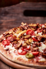 Gyros Pizza with jalapeno pepper, cherry tomatoes and mozzarella cheese. Soft focus. Close up.	