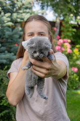 Woman Sneezing from Cat Allergy in Garden