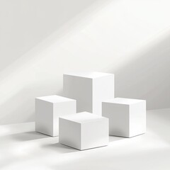 Four white cube display stands in sunlight