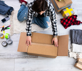 Girl Preparing For Moving By Packing Cardboard Boxes