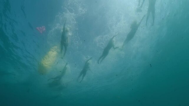 Athletes swimming underwater during triathlon competition