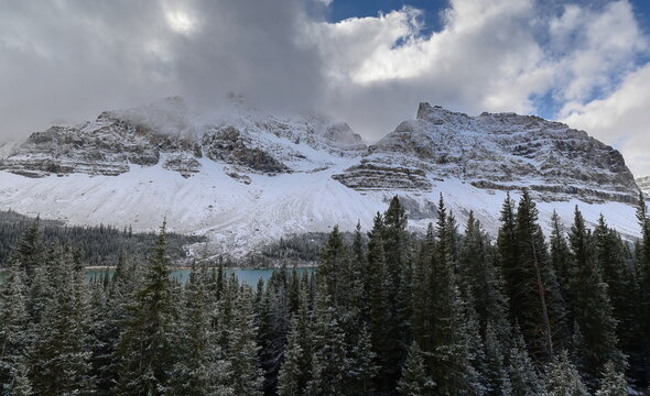 Snow-clad, misty Crowfoot Mountain with its (L-R) Center and North sections towering above Bow Lake emerald-green waters. Banff NP-Alberta-Canada-330