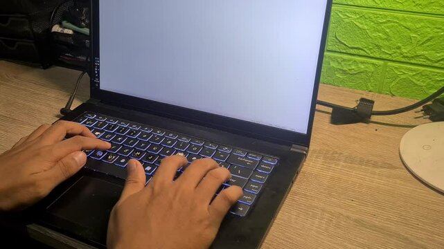 A close-up video of hands typing on a laptop placed on a work desk, showing productivity, focus, and a modern working environment in real time.